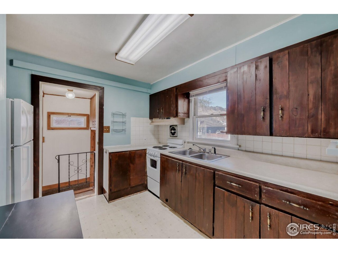 534 Dewey Avenue Boulder, CO 80304 - Photo 8 of 18 a kitchen with stainless steel appliances granite countertop a refrigerator a sink dishwasher and wooden cabinets with wooden floor