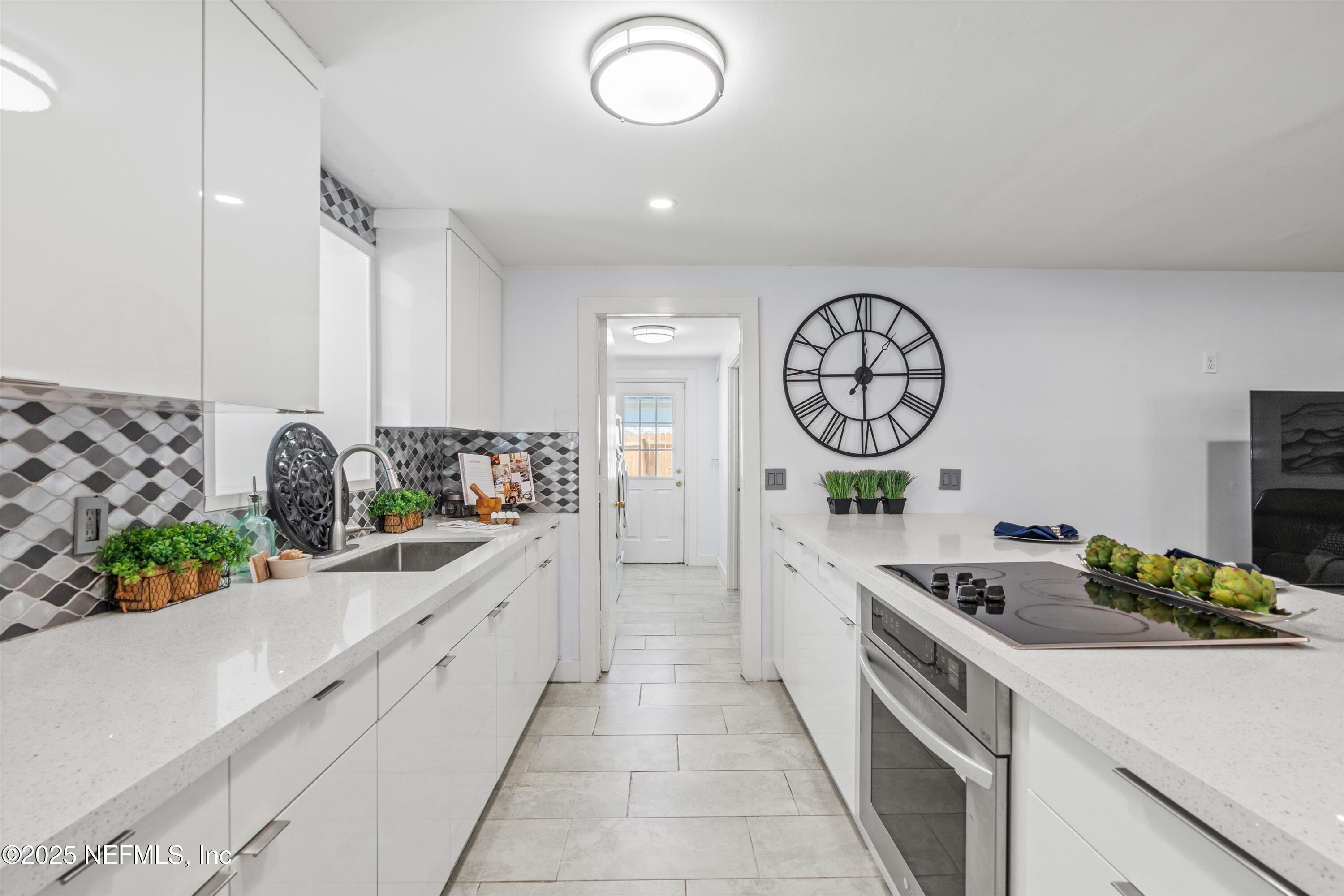 1216 Tumbleweed Drive Orange Park, FL 32065 - Photo 11 of 38 a kitchen with stainless steel appliances granite countertop a stove a sink and a refrigerator