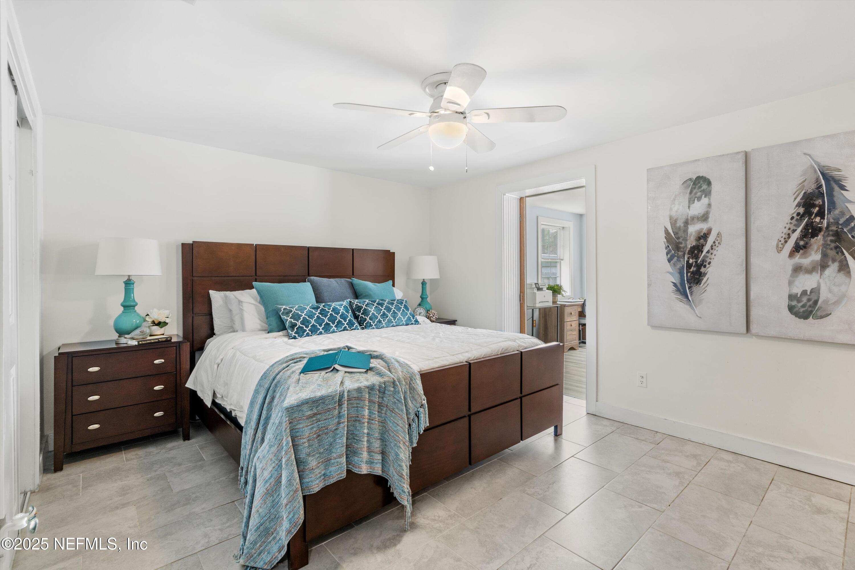 1216 Tumbleweed Drive Orange Park, FL 32065 - Photo 18 of 38 a bedroom with a bed and a painting on the wall