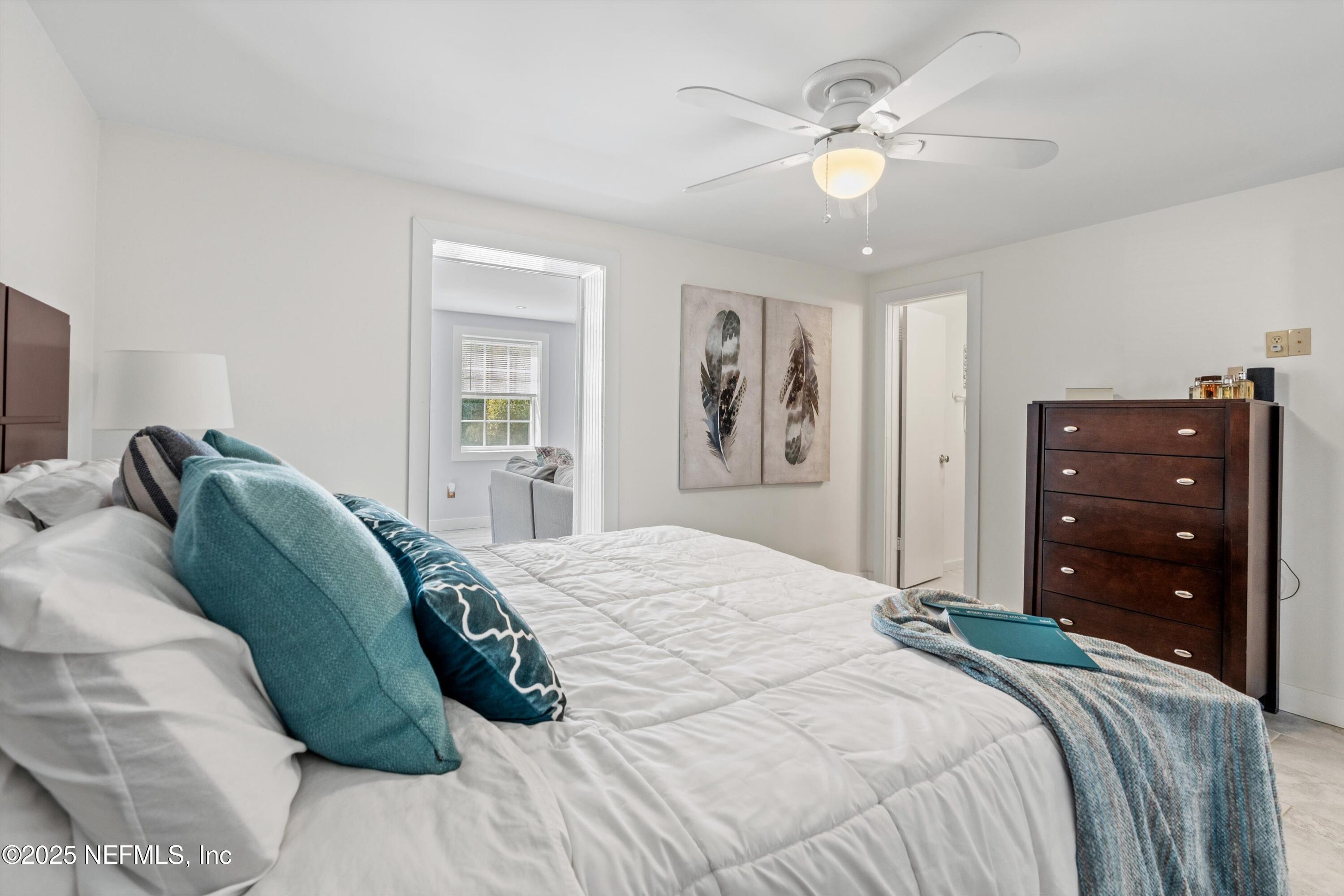 1216 Tumbleweed Drive Orange Park, FL 32065 - Photo 19 of 38 a bedroom with a bed and a chandelier