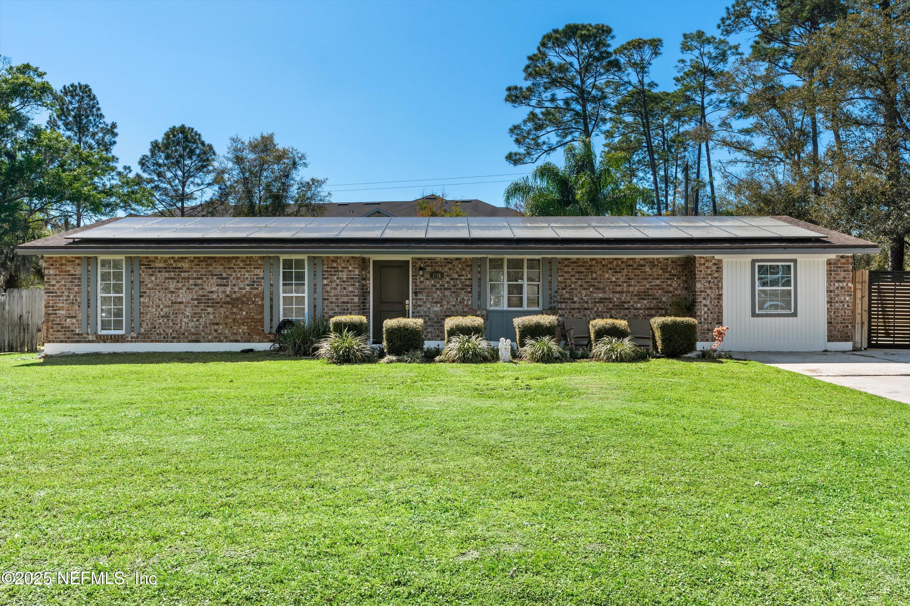 1216 Tumbleweed Drive Orange Park, FL 32065 - Photo 2 of 38 a front view of house with yard and outdoor seating