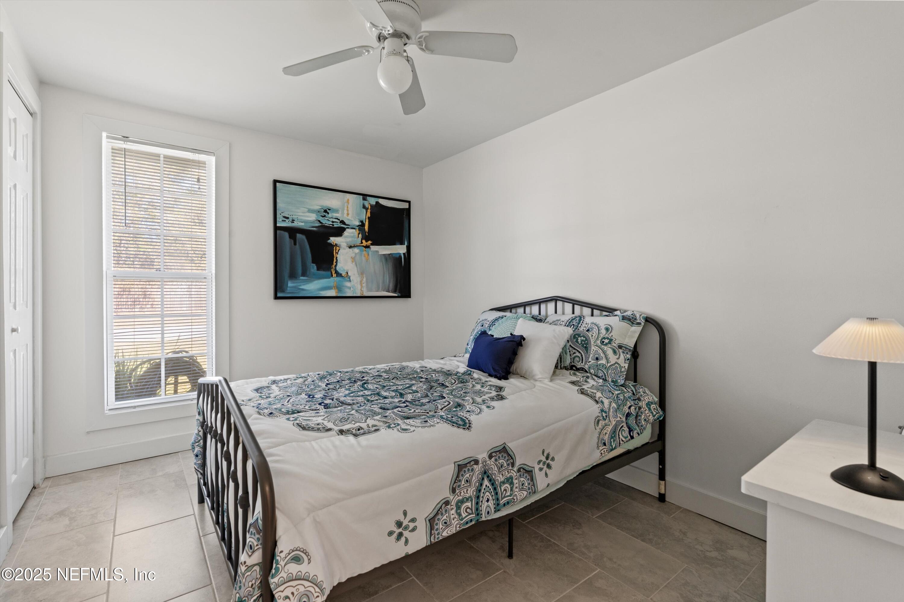 1216 Tumbleweed Drive Orange Park, FL 32065 - Photo 26 of 38 a bedroom with a bed and a table in it