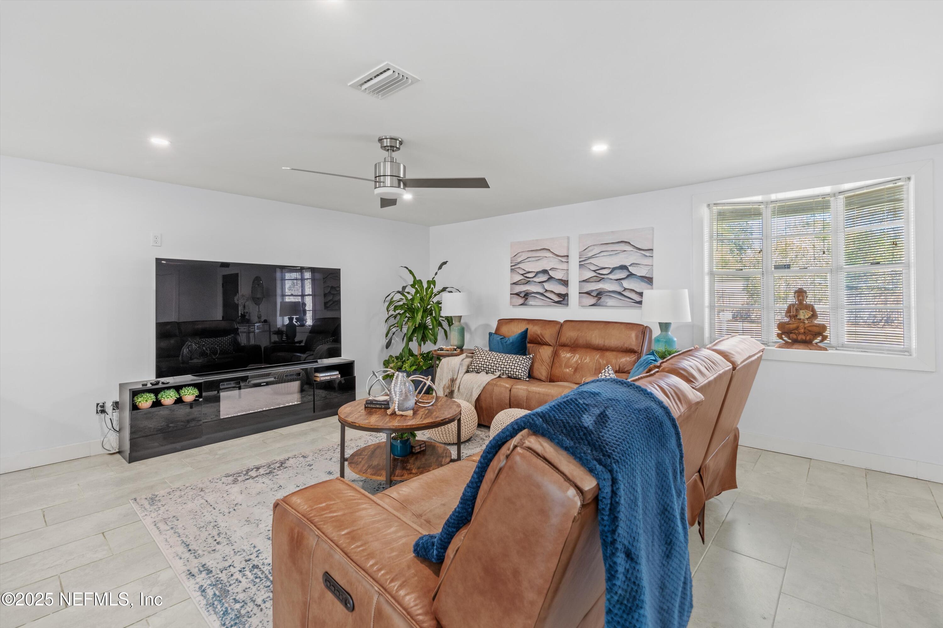 1216 Tumbleweed Drive Orange Park, FL 32065 - Photo 6 of 38 a living room with furniture and a flat screen tv