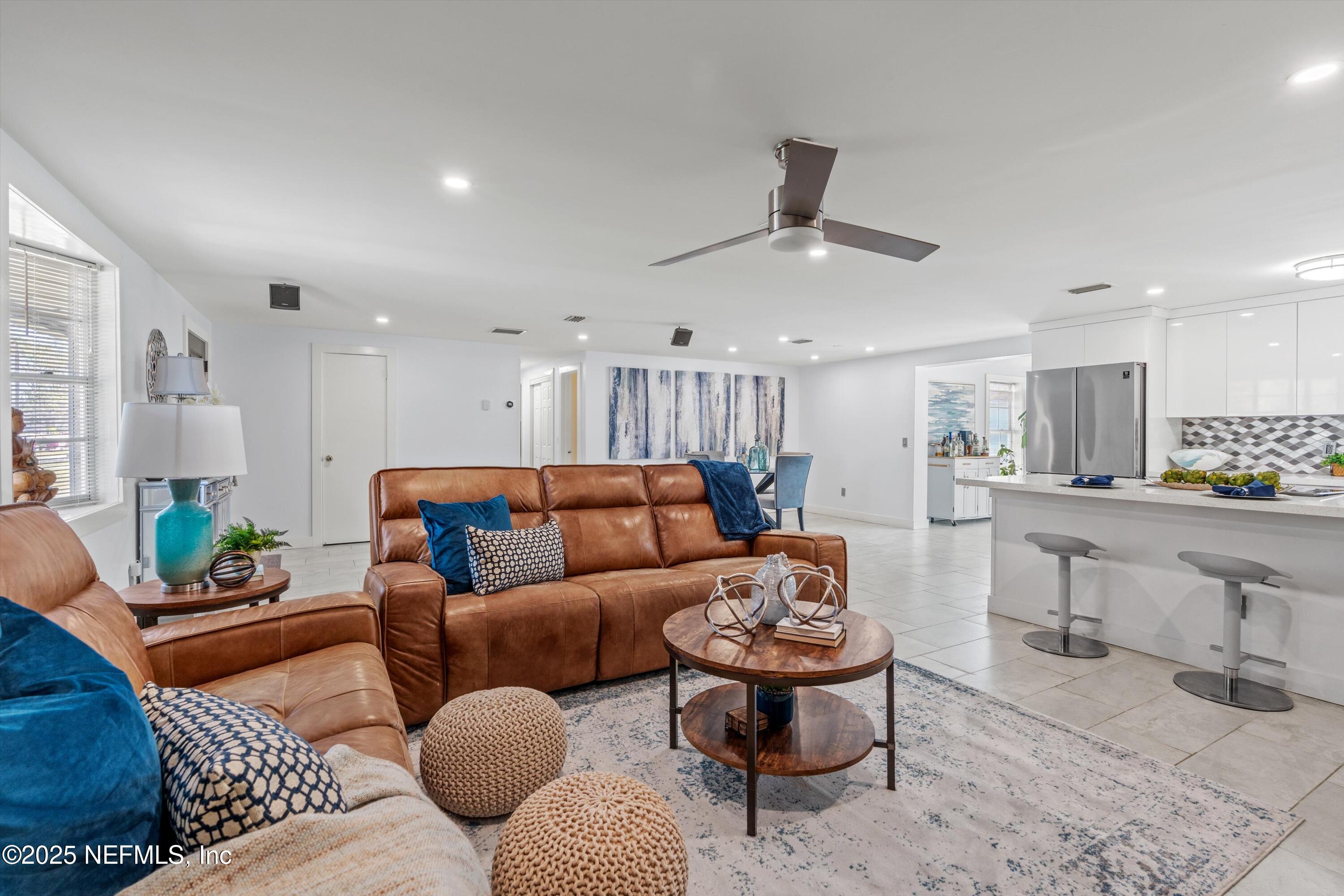1216 Tumbleweed Drive Orange Park, FL 32065 - Photo 8 of 38 a living room with furniture kitchen view and a chandelier