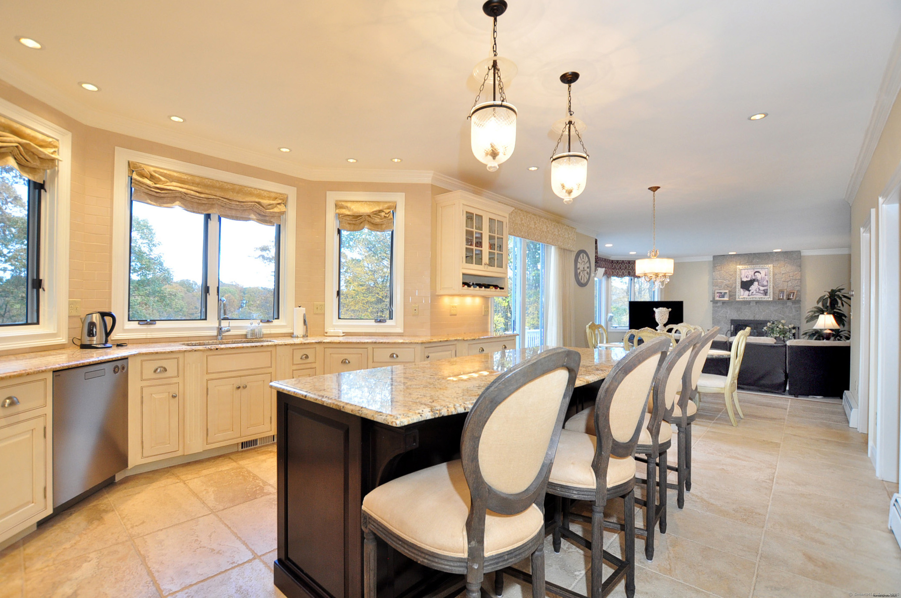 45 Lookout Landing Bolton, CT 06043 - Photo 12 of 39 a dining room with wooden floor a chandelier a glass table and chairs