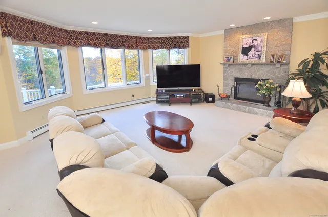 a living room with furniture a fireplace and a flat screen tv