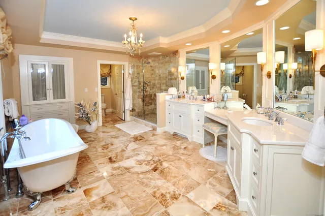 a large white kitchen with a large window