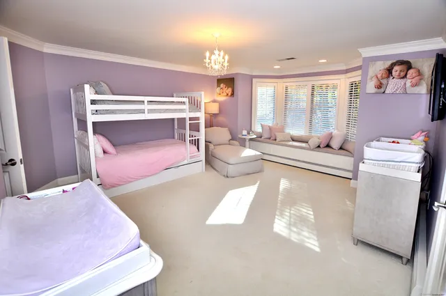 a bedroom with furniture and a chandelier