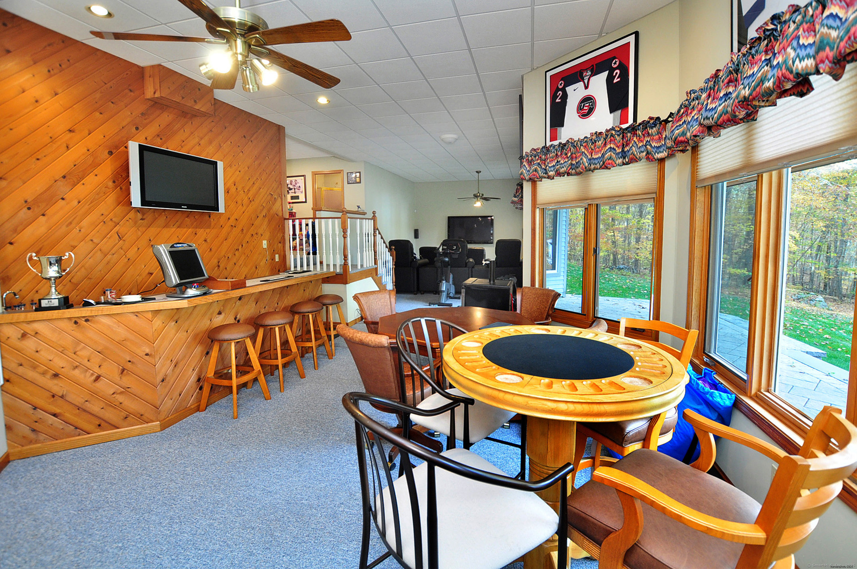 45 Lookout Landing Bolton, CT 06043 - Photo 29 of 39 a dining room with furniture a flat screen tv and a chandelier