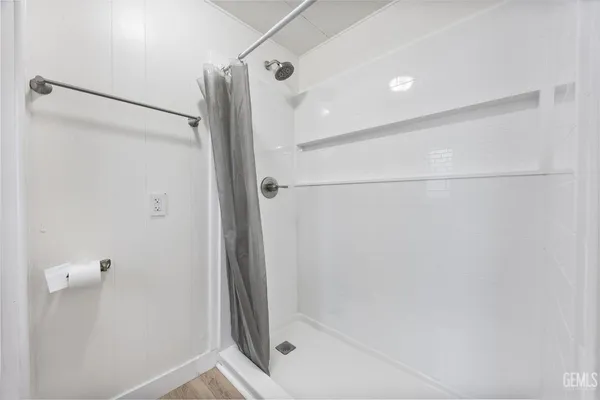 a bathroom with a shower and a glass door
