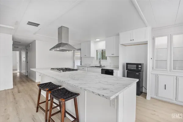 a kitchen with a stove a refrigerator and a fireplace