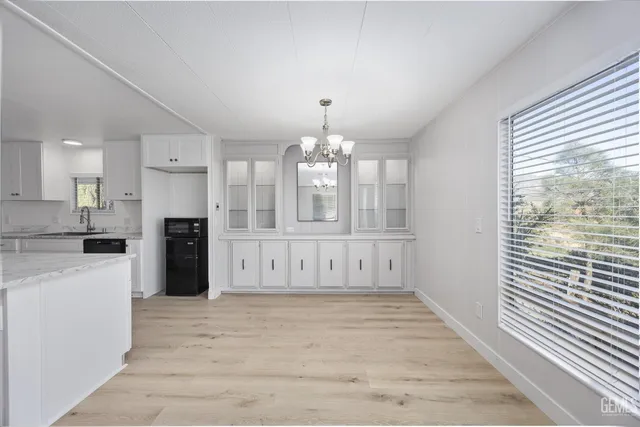 a view of kitchen with granite countertop cabinets and wooden floor