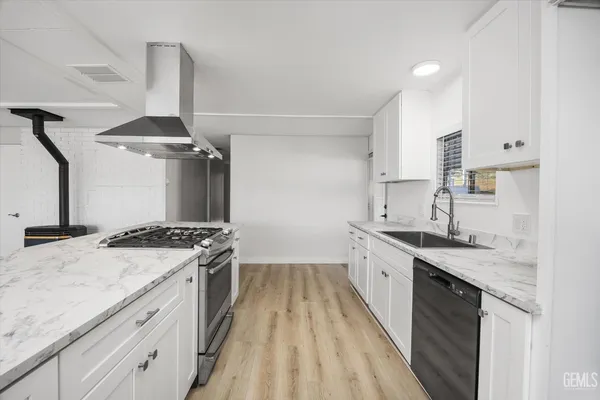 a kitchen with a sink stove and cabinets