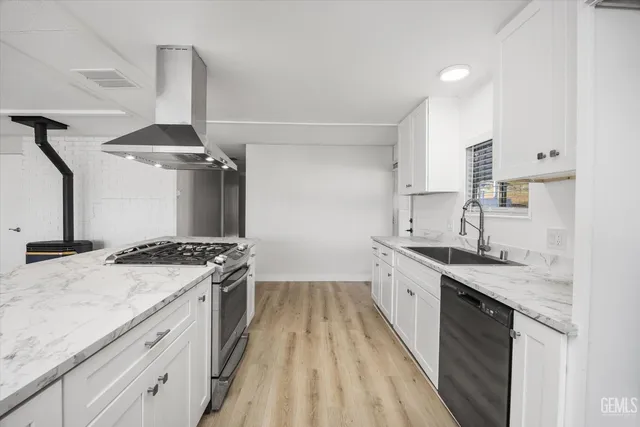 a kitchen with a sink stove and cabinets