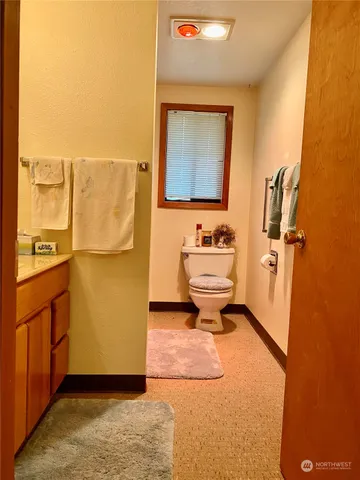 a bathroom with a toilet sink and mirror