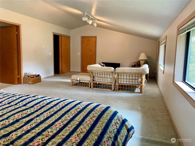 a room with a bed and a chandelier