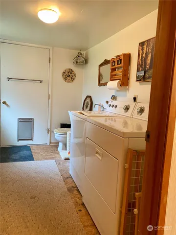 a bedroom with a bed and a white cabinet