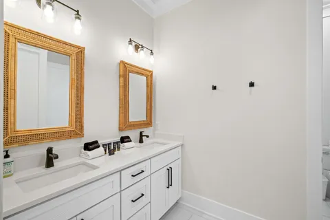 a bathroom with a double vanity sink mirror and
