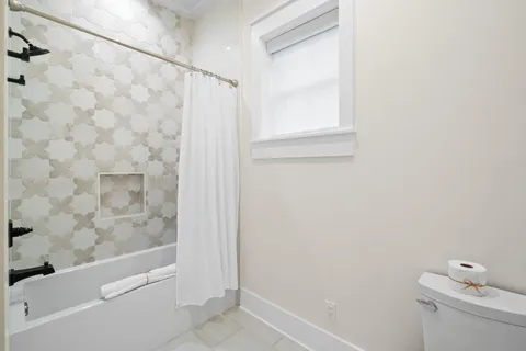 a very nice looking dining room with a large window and chairs