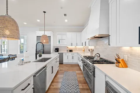 a bathroom with a double vanity sink mirror and a bathtub