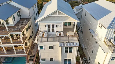a bedroom with a bed and large window