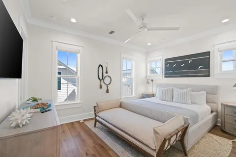 a bedroom with a bed and wooden floor