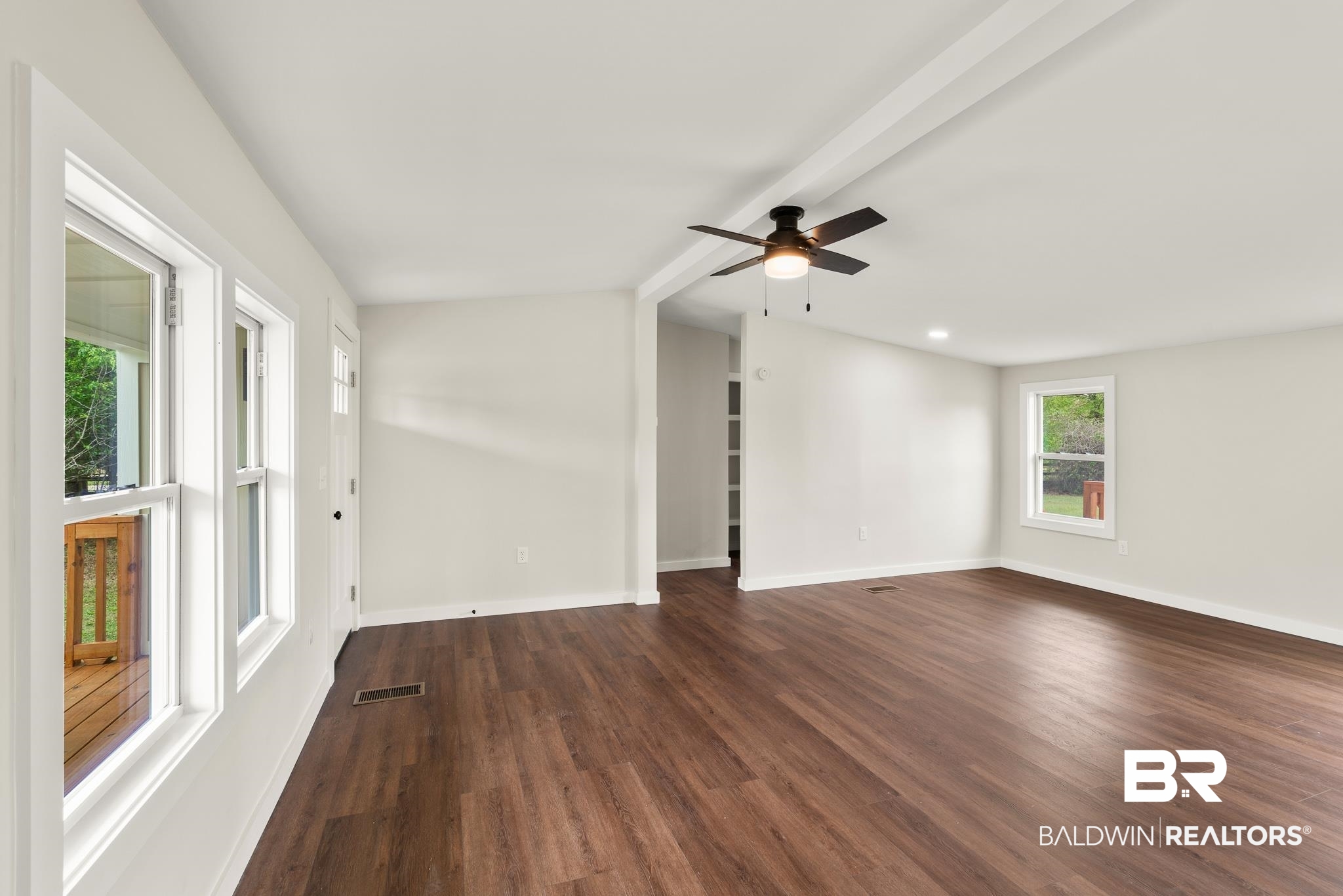 12645 Breman Road Elberta, AL 36530 - Photo 9 of 44 Spare room with a ceiling fan, visible vents, baseboards, and dark wood finished floors