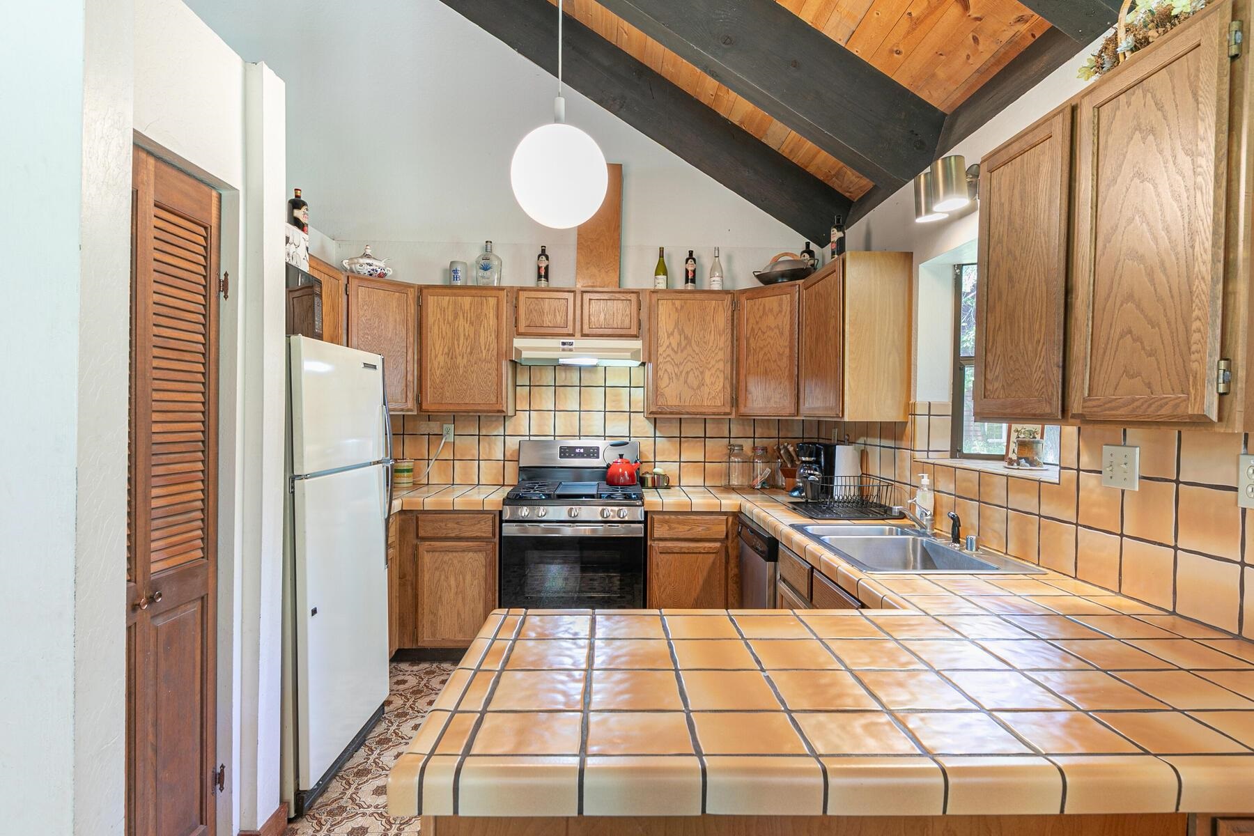 14620 Christie Lane Truckee, CA 96161 - Photo 17 of 28 a kitchen with a sink and a refrigerator