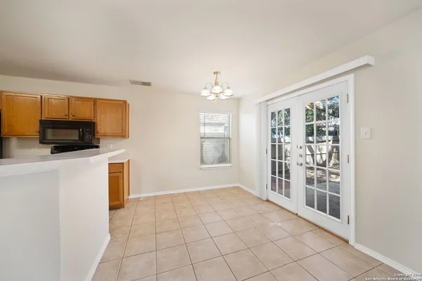 a view of a kitchen with microwave and cabinets
