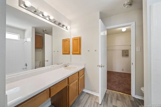 a bathroom with a sink a mirror and a shower