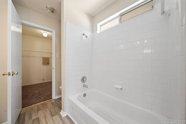 a bathroom with a bathtub and shower