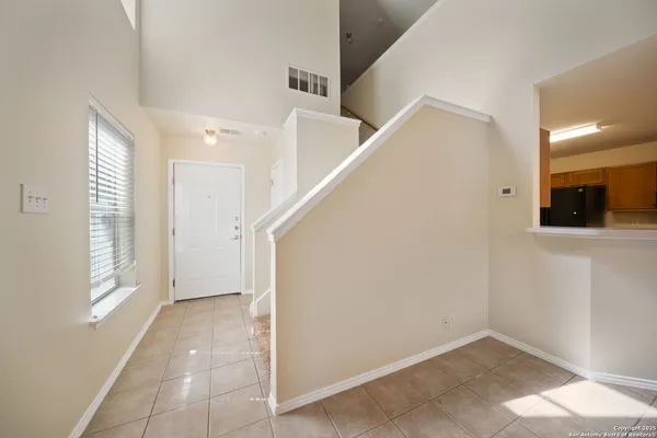 a view of hallway with window and stairs