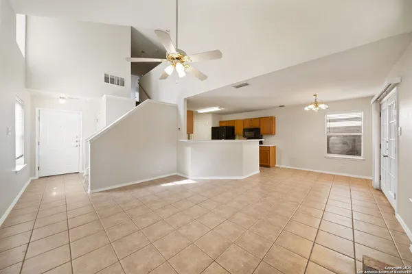 a view of a livingroom with a ceiling fan and window