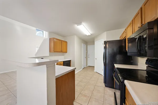 a kitchen with stainless steel appliances a refrigerator and a stove top oven