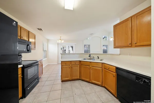 a kitchen with stainless steel appliances granite countertop a sink and cabinets