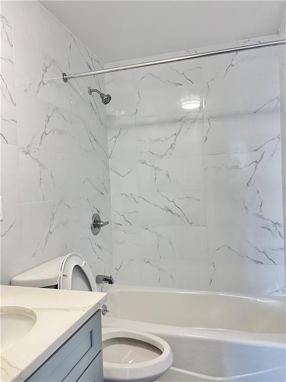 1651 85th Street Brooklyn, NY 11214 - Photo 5 of 17 a bathroom with a sink a toilet and a bathtub