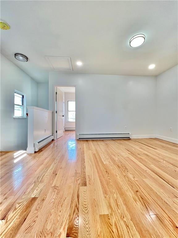 1651 85th Street Brooklyn, NY 11214 - Photo 6 of 17 a view of empty room with wooden floor and fan
