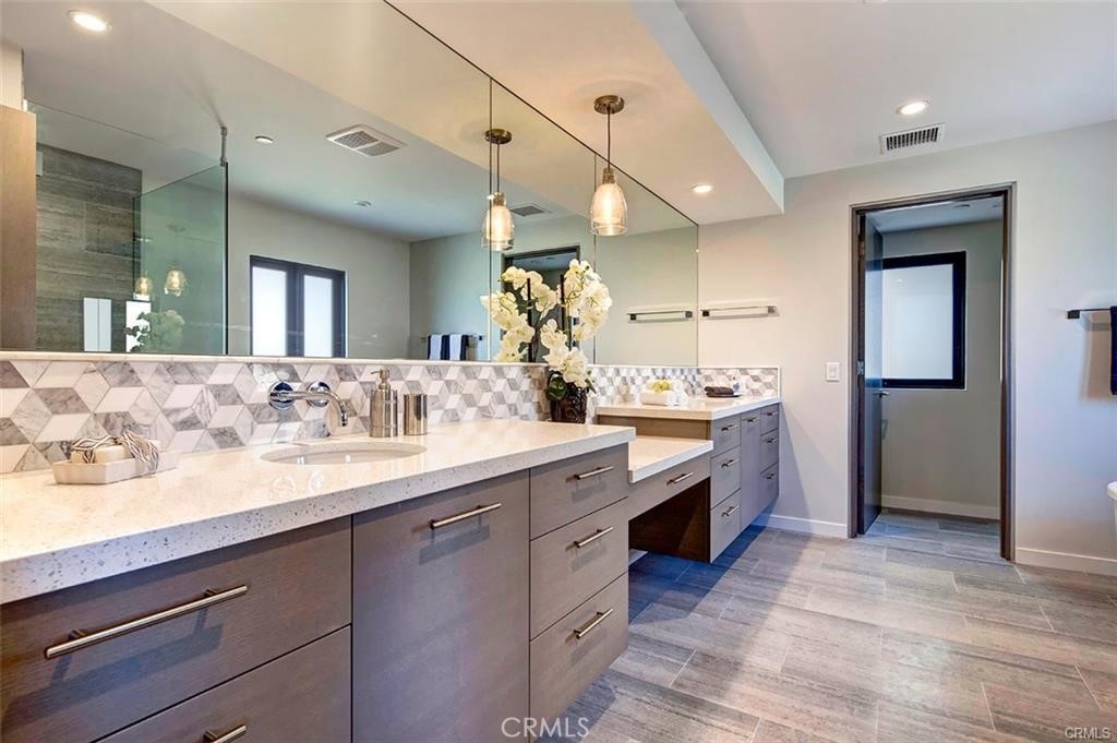606 Boundary Place Hermosa Beach, CA 90266 - Photo 12 of 13 a spacious bathroom with a granite countertop sink mirror and a shower