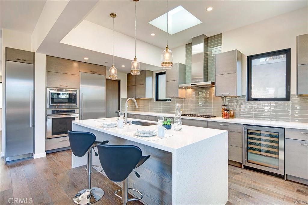 606 Boundary Place Hermosa Beach, CA 90266 - Photo 8 of 13 a kitchen with stainless steel appliances kitchen island granite countertop a sink and cabinets