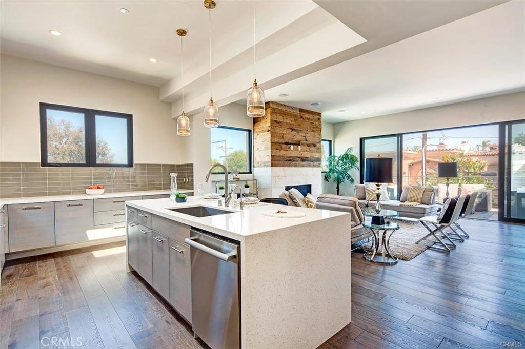 606 Boundary Place Hermosa Beach, CA 90266 - Photo 9 of 13 a kitchen with a sink stove and wooden cabinets
