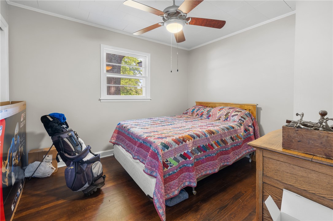 308 Buchanan Circle Pendleton, SC 29670 - Photo 11 of 19 This cozy bedroom features warm wood flooring and ample natural light, creating a comfortable ambiance.