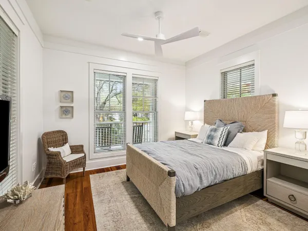 a bedroom with a bed and a large window