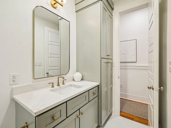 a bathroom with a sink vanity and a mirror