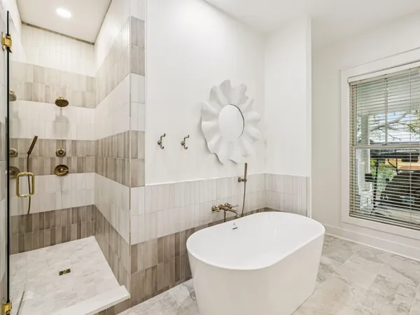 a bathroom with a bathtub and shower