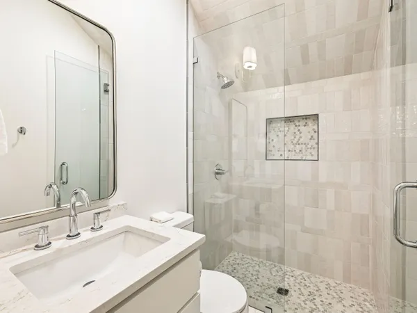 a bathroom with a sink toilet and shower