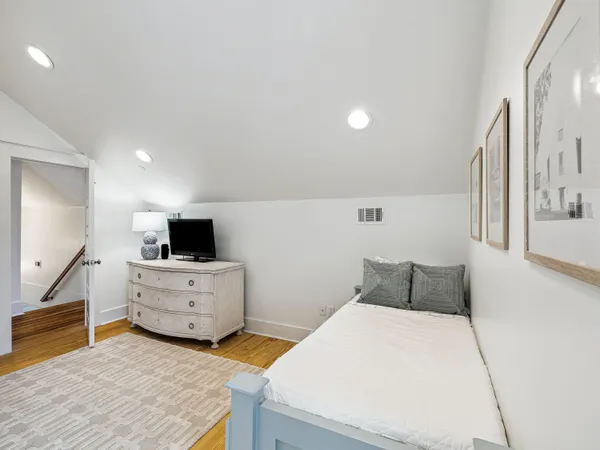 a bedroom with furniture and flat screen tv