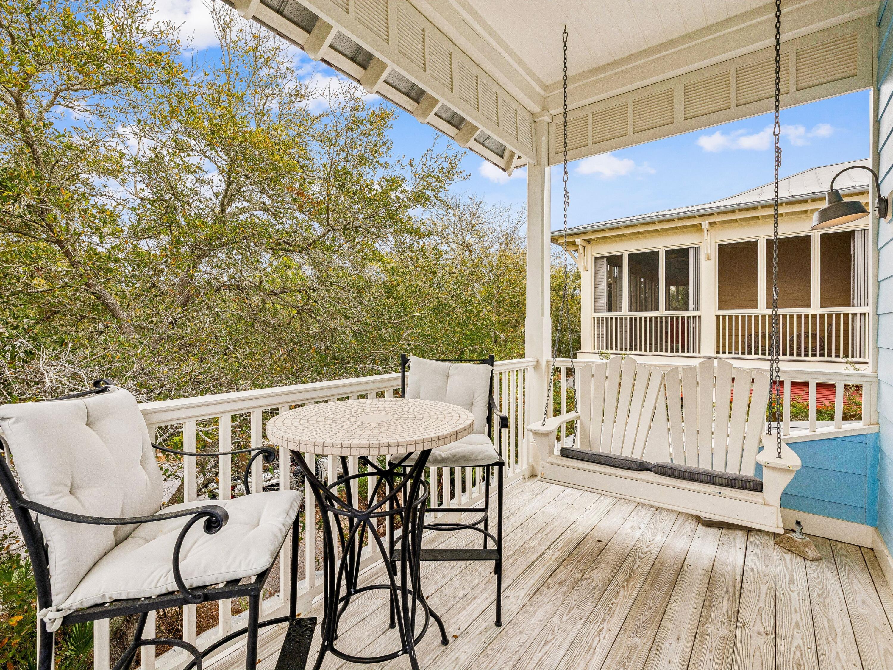 90 Silver Laurel Way Santa Rosa Beach, FL 32459 - Photo 36 of 45 a view of a patio with table and chairs with wooden floor and fence