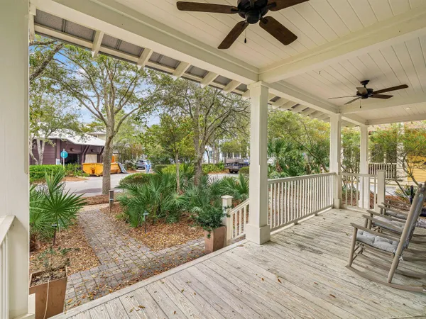 a view of a porch with furniture and garden