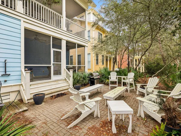 a view of a patio with table and chairs and floor to ceiling window