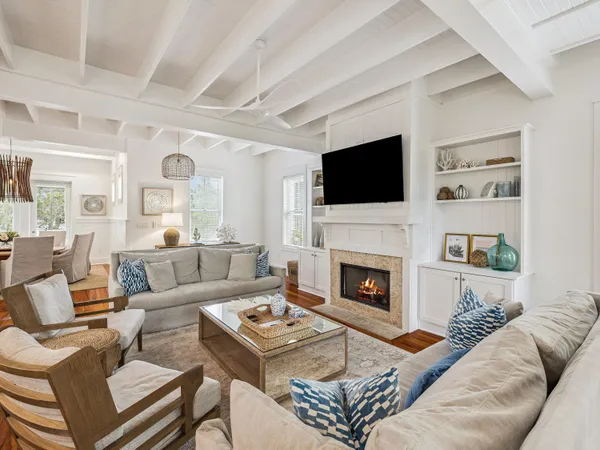 a living room with furniture a fireplace and a flat screen tv